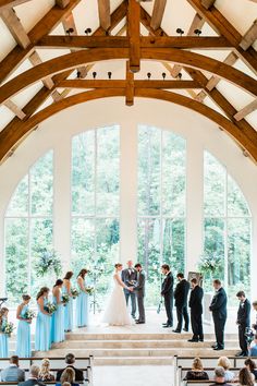 a group of people standing on top of a church pews next to each other