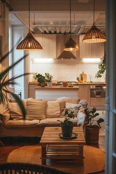 a living room filled with lots of furniture next to a table and potted plants