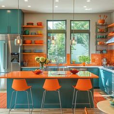 an orange and blue kitchen with stainless steel appliances, cabinets, counter tops, and stools