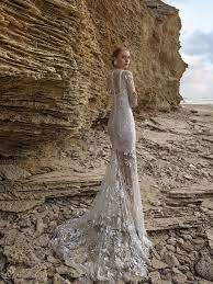 a woman is standing in front of some rocks