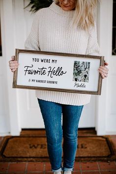 a woman holding a sign that says you were my favorite nelson