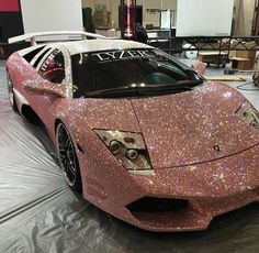 a pink sports car covered in glitter