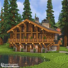 a large wooden house sitting in the middle of a lush green forest next to a lake