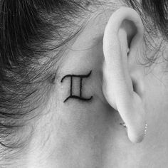 a woman's behind the ear has a small pi symbol on it