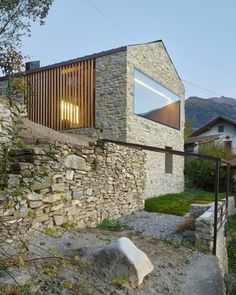 the house is made out of stone and has a small window on it's side