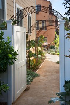 an open door leading to a house with a garden in the front yard and outside