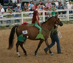 a woman riding on the back of a brown horse