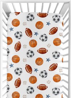 a baby crib bed with sports themed sheets