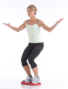 a woman standing on top of a skateboard in front of a white background with her arms out