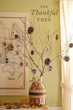 there is a tree that has been decorated with buttons and branches in a vase on the table