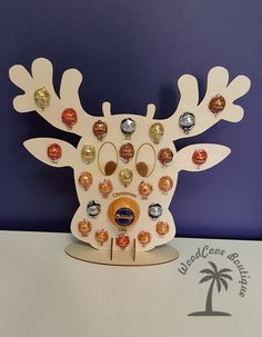 a wooden reindeer head with lots of different colored buttons on it's antlers