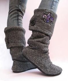 a woman's legs wearing gray boots with purple flowers on them