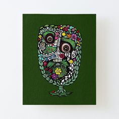 a painting of a green skull with flowers on it's head canvas mounted print