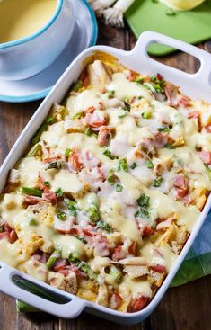 a casserole dish with meat, cheese and veggies in it on a wooden table