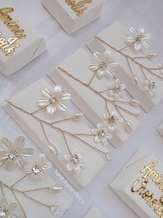 many different types of birthday cards with flowers and chains on the front one is gold, the other is white