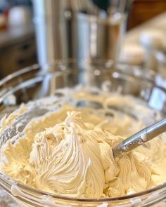 a bowl filled with white frosting sitting on top of a table