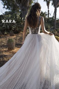 the back of a woman's wedding dress in white crochet and beading