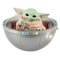 the baby yoda is sitting in an electronic device