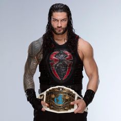 a man with long hair and tattoos holding a wrestling belt in his hands while standing against a white background