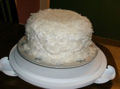 a white cake sitting on top of a wooden table