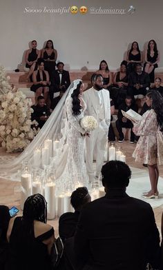 the bride and groom are getting married in front of an audience