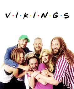 a group of people standing next to each other with the words vikings on them