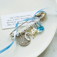 a white plate topped with a blue ribbon and charms