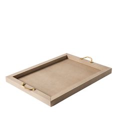 a wooden tray with gold handles