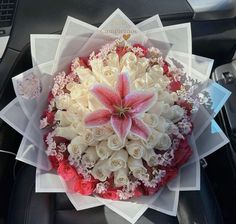 a bouquet of flowers sitting on top of a car seat