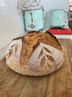 a loaf of bread sitting on top of a wooden cutting board