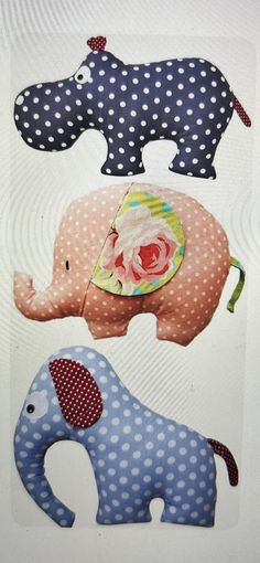 an elephant, giraffe and baby elephant are made out of polka dot fabric