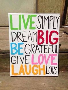 a sign that says live simply dream big be grateful give love laugh lots