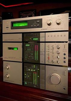 an array of electronic equipment sitting on top of a wooden table