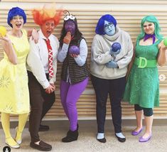 four women dressed in costumes posing for a photo