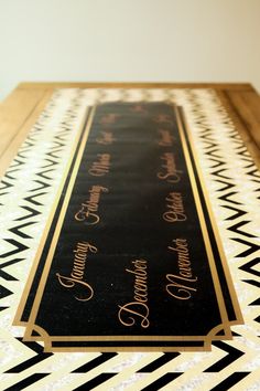 a black and white rug with gold lettering on it