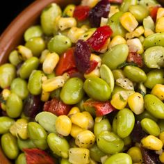 a bowl filled with green beans and red peppers