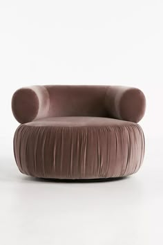 a chair with a round shaped cushion on the top and bottom, in front of a white background