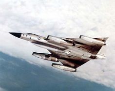 a fighter jet flying through the sky with clouds in the backgrounds