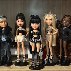 several dolls are lined up on a shelf