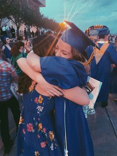 two girls hugging each other at graduation