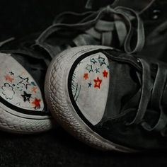 two pairs of shoes with stars painted on them