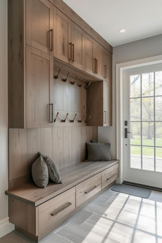 a wooden bench sitting in the middle of a room next to a sliding glass door