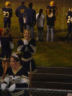 the cheerleaders are sitting on the bleachers