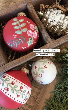 two red and white ornaments in a wooden box