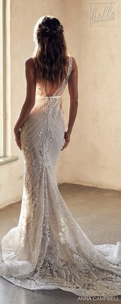 the back of a woman's wedding dress in an empty room