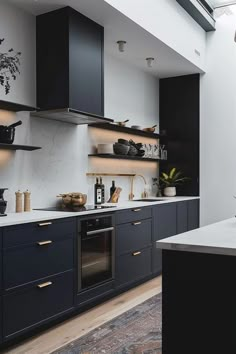 a kitchen with black cabinets and white counter tops is seen in this image from the inside