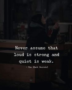 a person sitting at a table with a quote on it that says never assume that loud is strong and quiet is weak