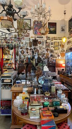 a room filled with lots of assorted items and pictures on the wall above it