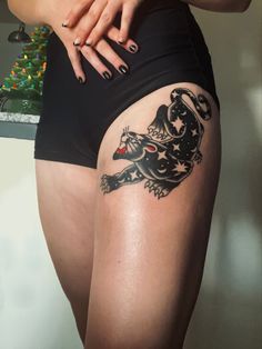 a woman with tattoos on her thigh and leg