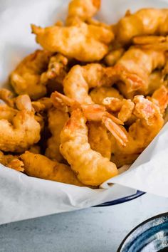 some fried food is in a basket on the table